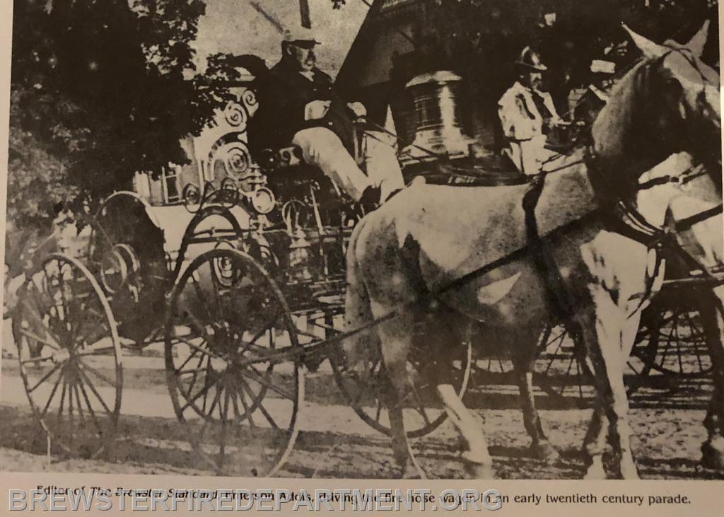 Photo #7
Emerson Addis, (died 1922) editor of The Brewster Standard driving hose cart in early twentieth century parade