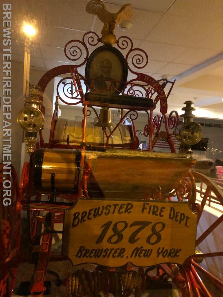 Photo #29
Front view of Hose Cart currently on display through glass panel at Brewster Fire Department.