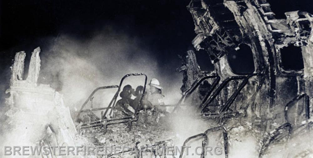 A Chief and firefighters by remains of Lockheed Super Constellation that night.