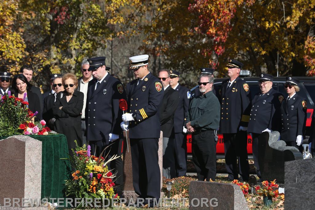 Chief planting Grave Marker; 
President inserting firefighter flag in Grave Marker
