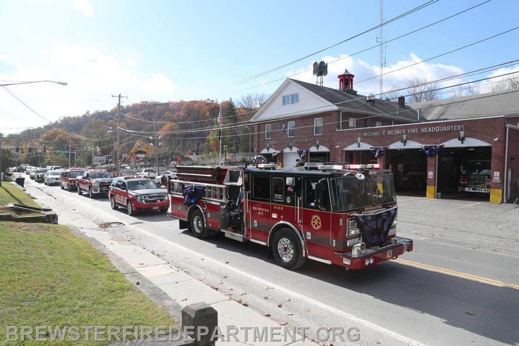 Sounding the last alarm as procession passes the Brewster Fire Department on North Main Street