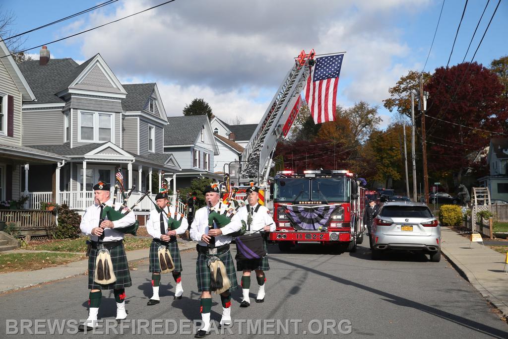  FDNY Emerald Society Pipe Band leading procession to St. Lawrence Church.